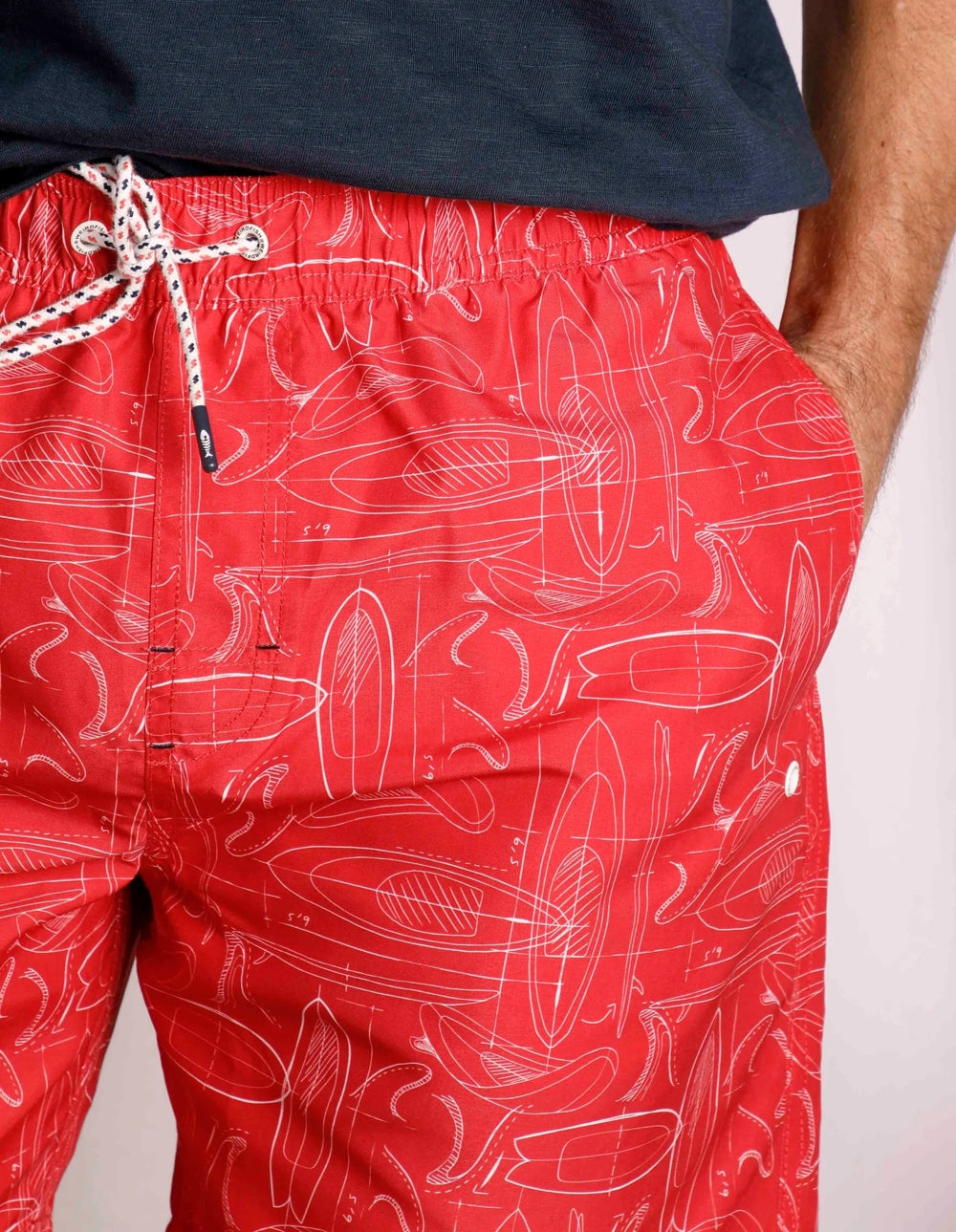 Weird Fish men's Belukha Radical Red swim shorts with surfboard print and hip pockets.