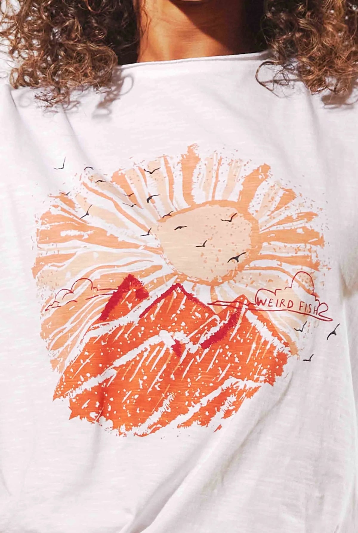 Weird Fish women's Sundown t-shirt in White with an orange sun and landscape print.