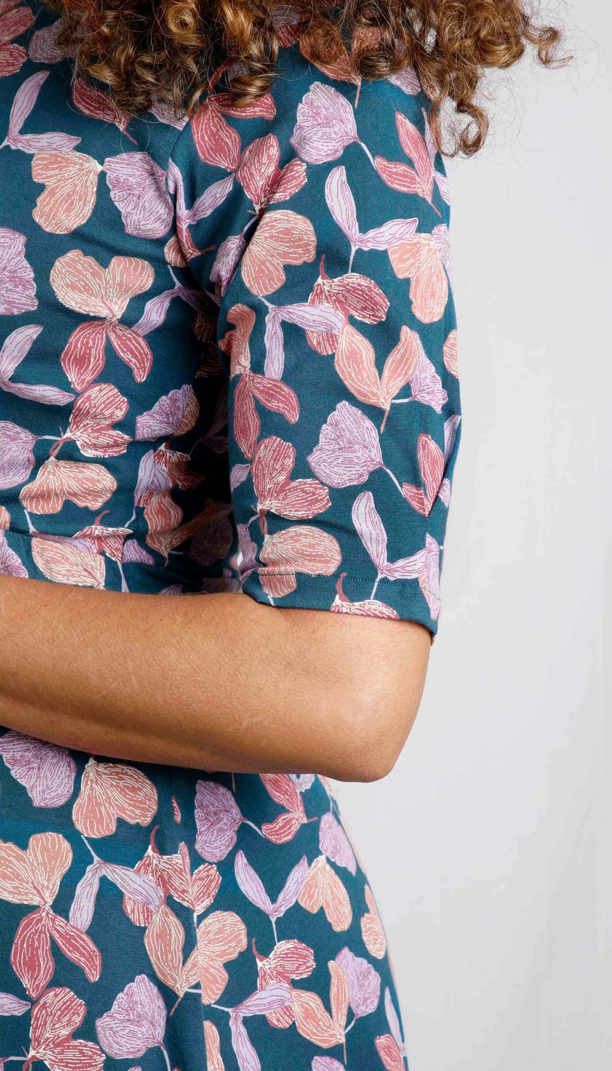 Women's Cassandra dress from Weird Fish in Deep Sea Blue with a purple floral pattern and 1/2 length sleeves.