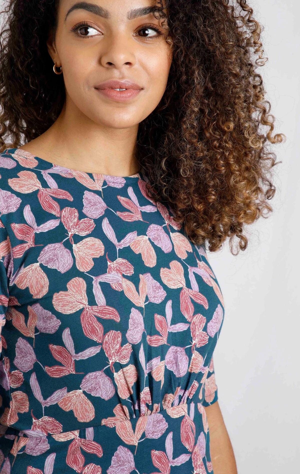 Weird Fish women's Cassndra dress in Deep Sea Blue with a purple, red and orange floral print and gathered fabric at the empire line for a swing style fit.