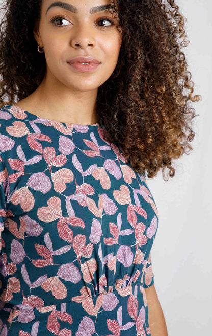 Weird Fish women's Cassndra dress in Deep Sea Blue with a purple, red and orange floral print and gathered fabric at the empire line for a swing style fit.