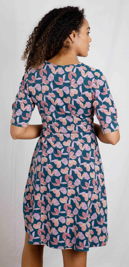 Women's half length sleeve Cassandra swing dress from Weird Fish in Deep Sea Blue with a purple floral pattern.