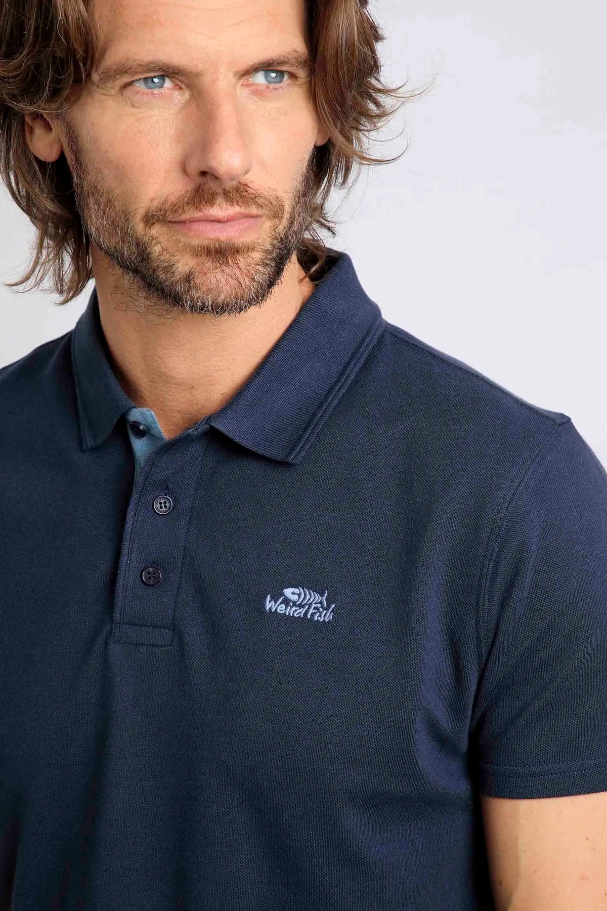Weird Fish men's Miles pique polo shirt in Navy with small chest logo emblem.