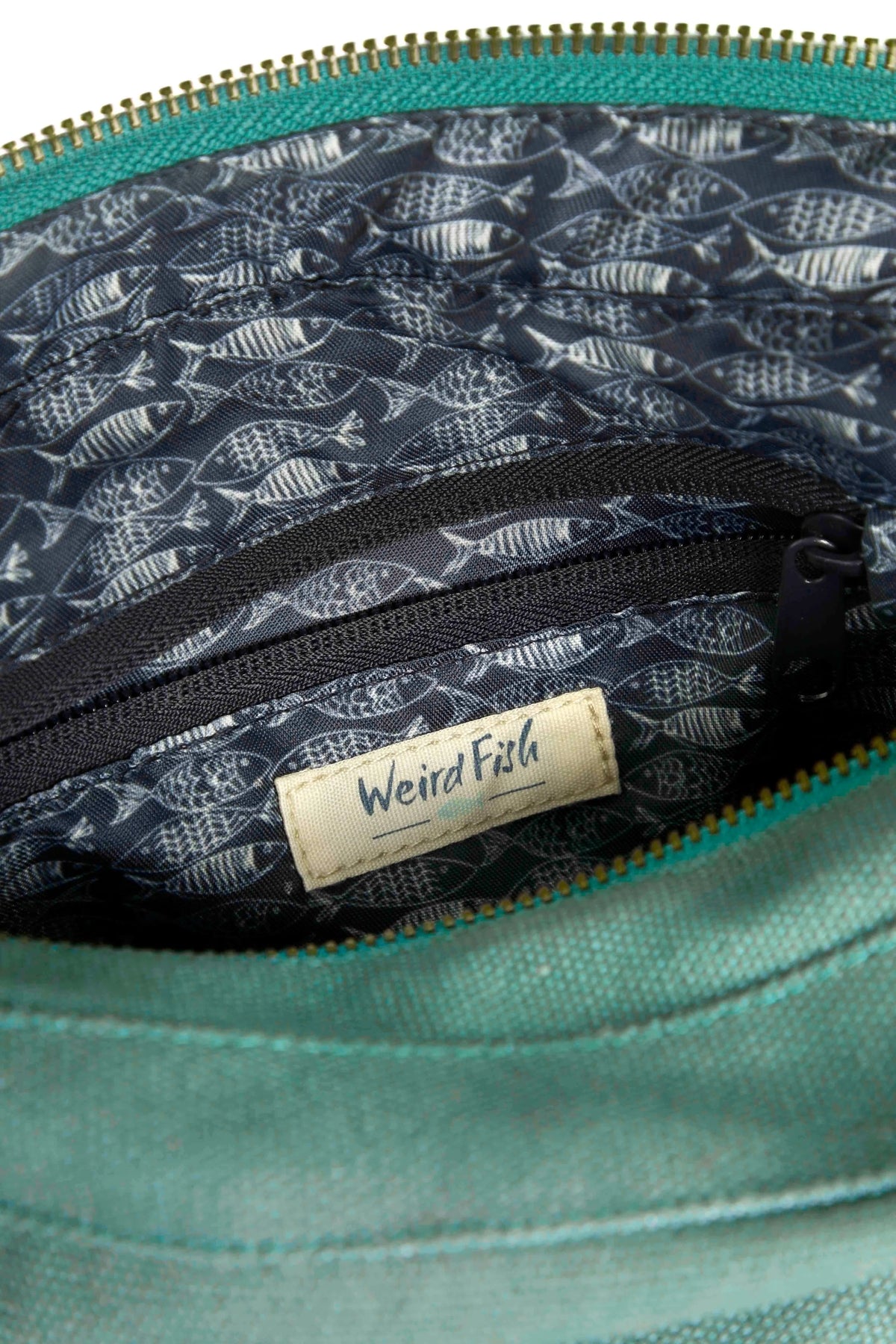 Weird Fish Ataca canvas cross body bag in Jade Green with fish print lining and internal zip pocket.