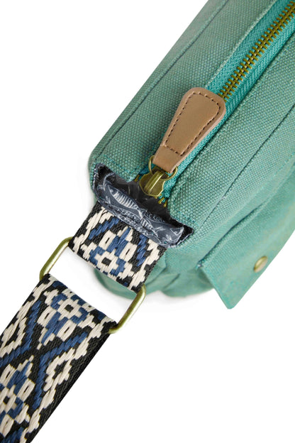 Atace canvas cross body bag from Weird Fish in Dark Jade Green with adjustable strap and zip top main compartment.