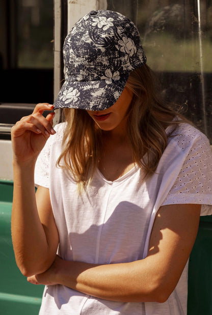 Rigg cap from Weird Fish in a Dark Denim Blue and White tropical floral pattern.