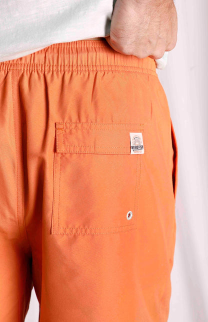 Men's Weird Fish Banning swimshorts from Weird Fish with elasticated waist and back pocket in plain Mango Orange.