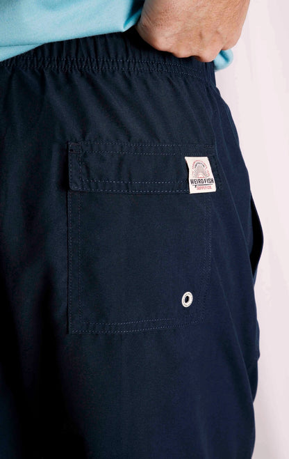 Men's Banning swim shorts from Weird Fish in plain Navy with back Velcro pocket with logo label.