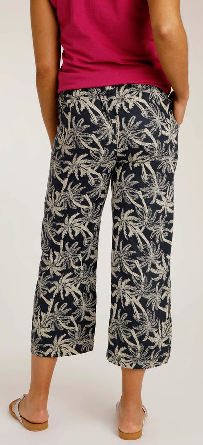 Women's crop trousers from Weird Fish with a palm tree pattern.