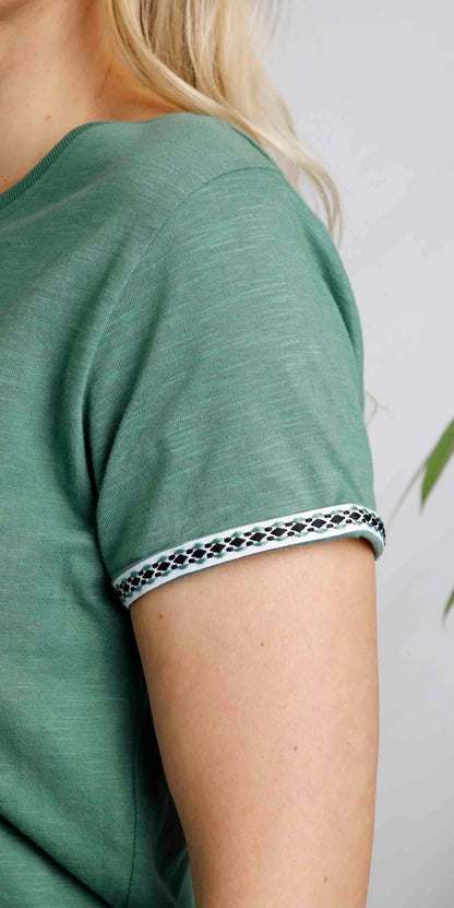 Women's short sleeve Teya tee in Dark Jade with embroidered tape sleeve trim.