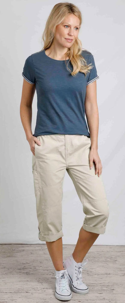 Weird Fish womens Teya t-shirt in China Blue on model with striped sleeve trim paired with beige cropped trousers and white sneakers