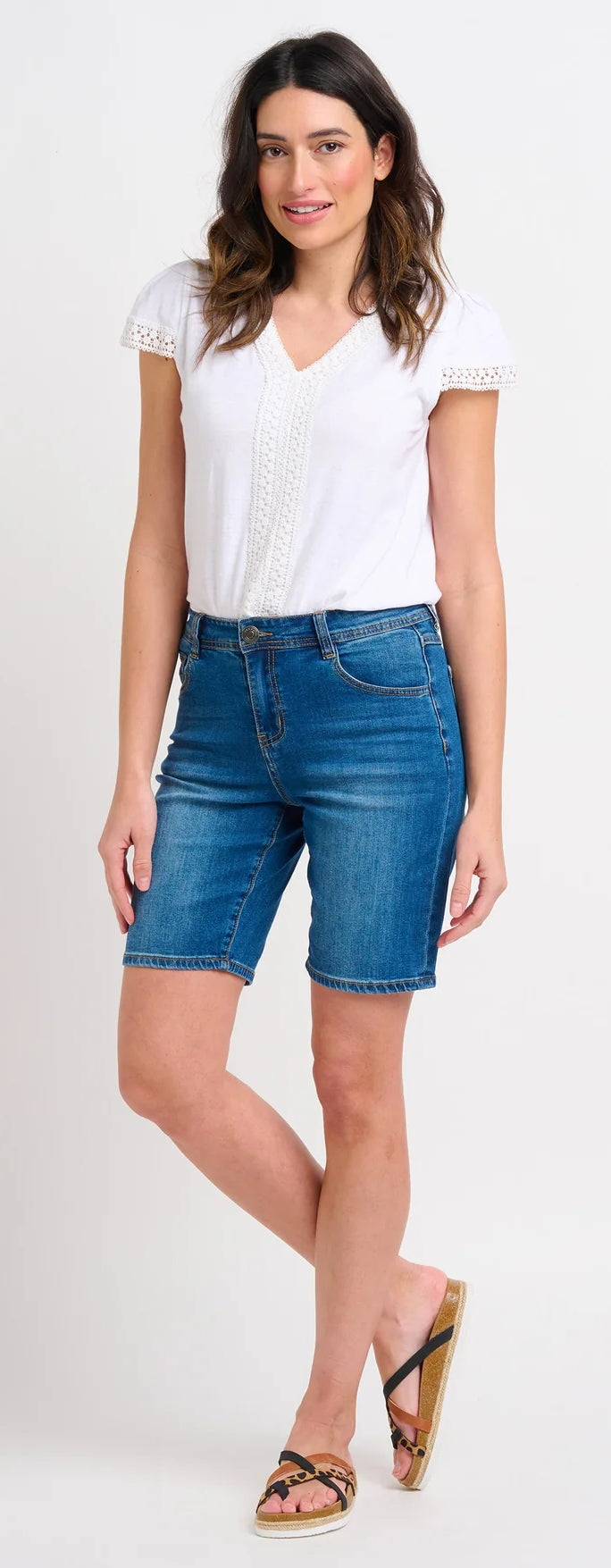 Brakeburn womens blue denim shorts modeled with white blouse and sandals