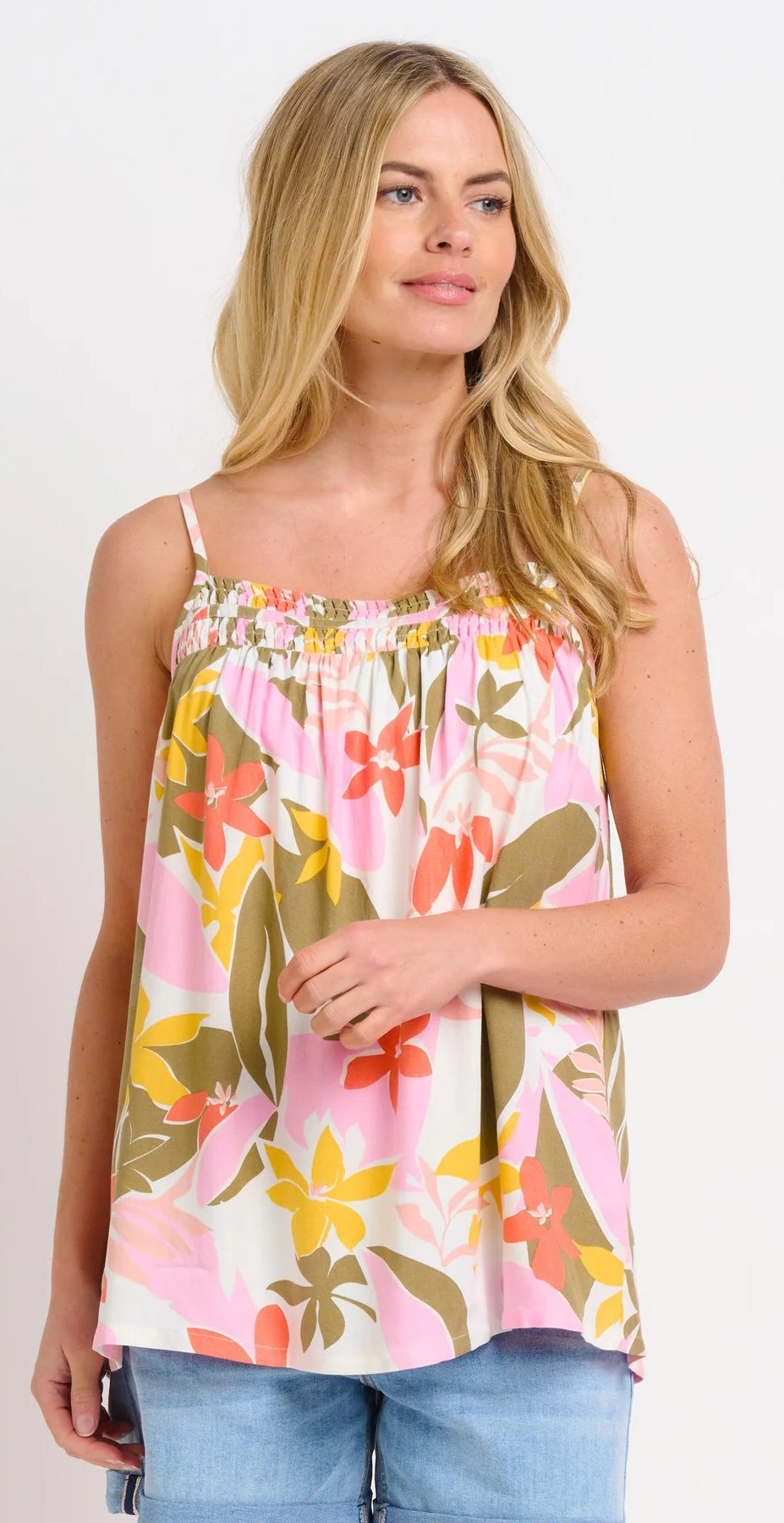 Brakeburn womens tropical print vest with pink orange and green floral design worn with blue jeans