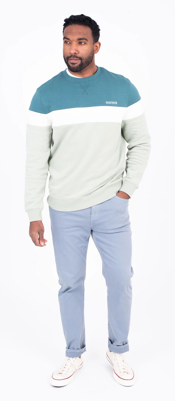 A men's crew neck sweatshirt from Brakeburn in a colour block pattern of green, blue or teal.