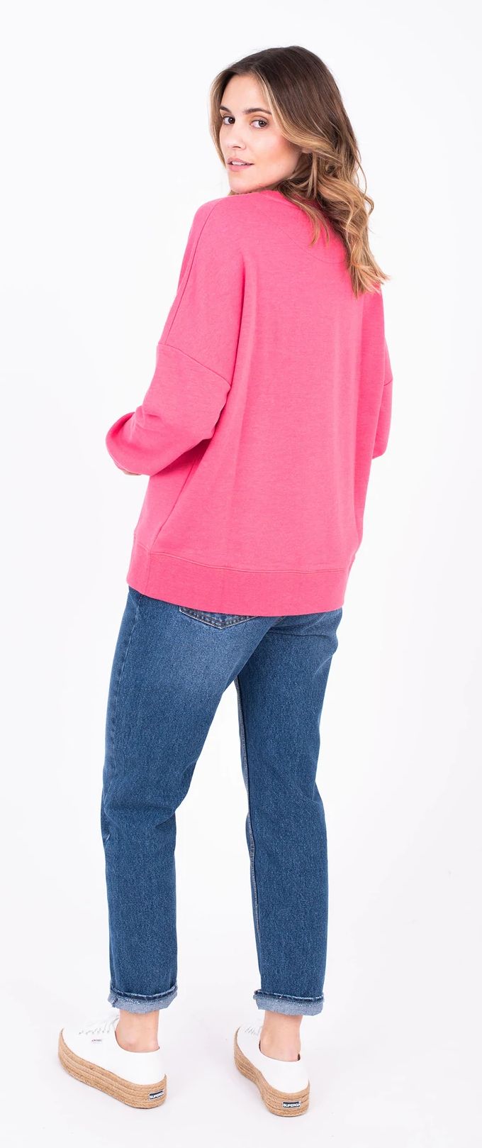 Brakeburn women's sweater in bright pink with Apres Surf print on the front and a plain back.