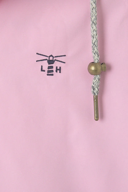 Close-up of Lighthouse womens waterproof jacket pink showing logo and drawstring details