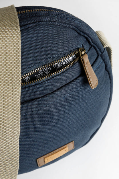 Circular shape canvas cross body bag from Weird Fish in Navy with zip pockets.